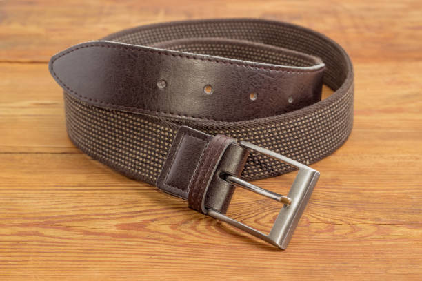 istock Brown stretch belt closeup on an old wooden surface 881471628