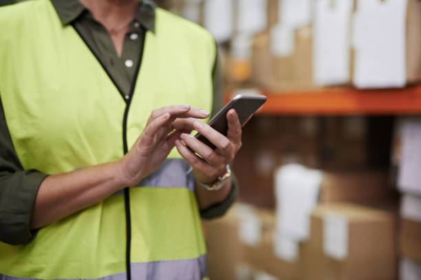 istock Managing the warehouse from her smartphone 881472068