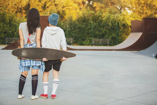 istock One skate, two girls 881474496