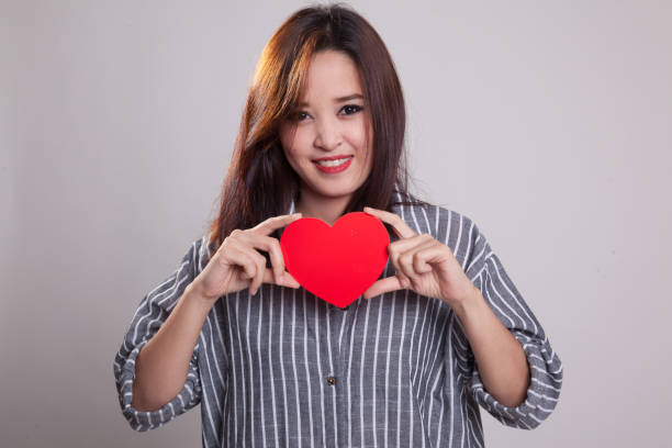 istock Asian woman with red heart. 881474996