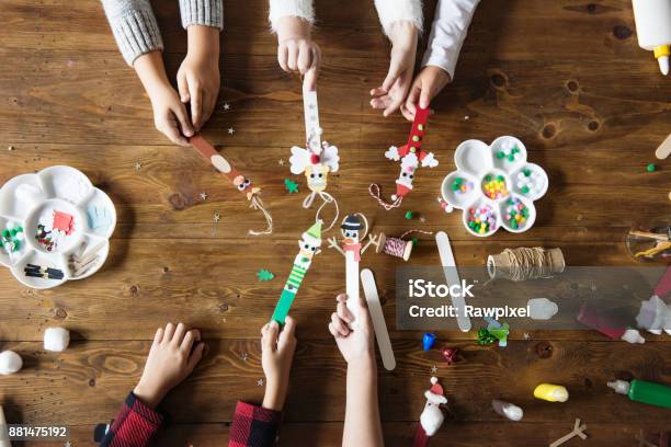 Little Kids Holding Christmas Character Decorated Popsicle Sticks Stock Photo - Download Image Now