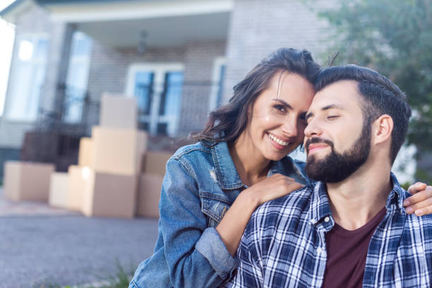 istock couple in front of new house 881477456
