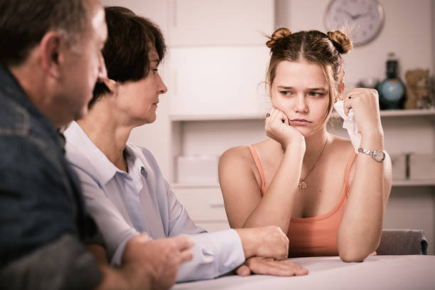istock Mom and dad are supporting a sad daughter at the table 881480726
