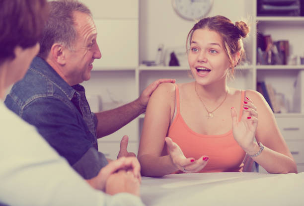 istock Happy family is talking about life at the table 881480736