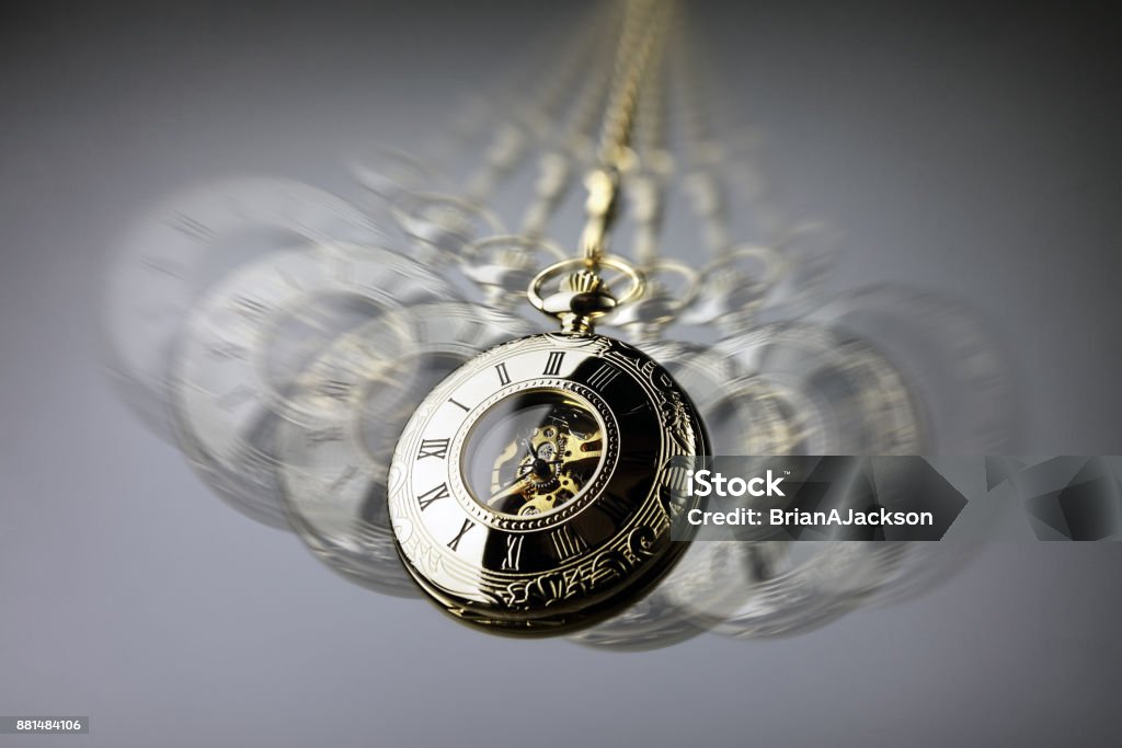 Hypnosis pocket watch Hypnotism concept, gold pocket watch swinging used in hypnosis treatment Hypnosis Stock Photo