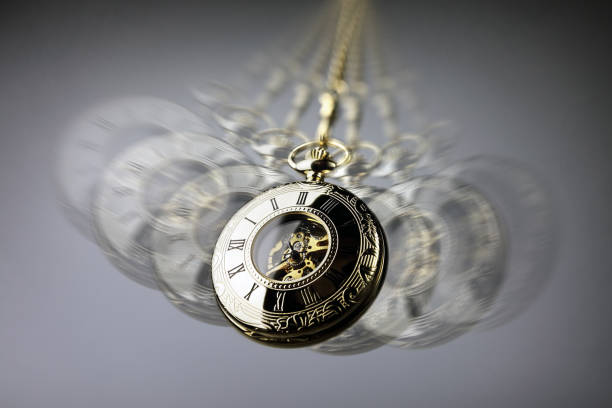 Hypnosis pocket watch Hypnotism concept, gold pocket watch swinging used in hypnosis treatment psyche photography stock pictures, royalty-free photos & images