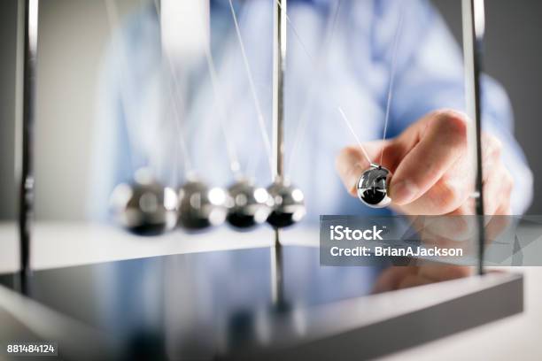 Newtons Cradle Businessman Concept For Cause And Effect Stock Photo - Download Image Now