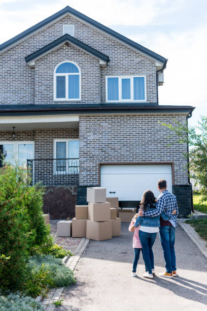 istock family looking at new house 881484324