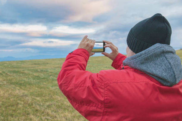istock Man taking photos with cellphone in nature. 881485066