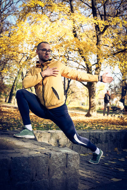 istock Young man stretching arms  after exercise. On the move. 881488312