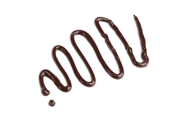 istock Hot melted chocolate pouring isolated on white background, top view 881488642