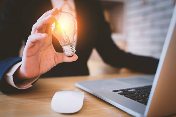 istock Businesswoman holding light bulb. 881493772