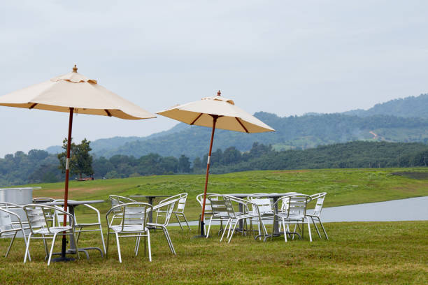 istock Comfortable lounge chairs and tables, relaxing background by the lake 881493812