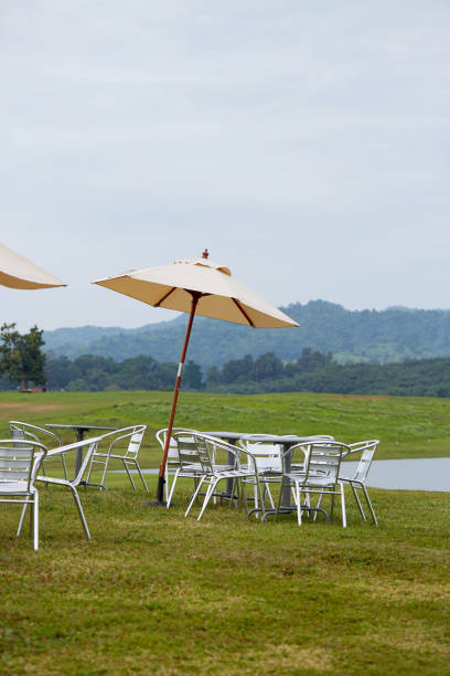 istock Comfortable lounge chairs and tables, relaxing background by the lake 881493814
