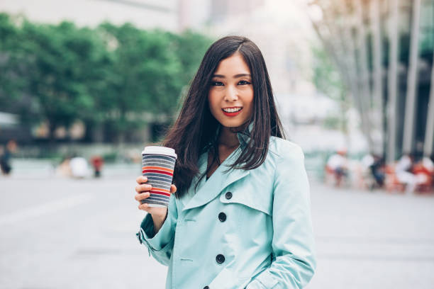 istock Young businesswoman holding a coffee cup 881497158