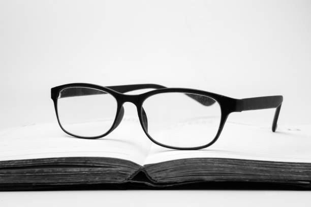 istock Eyeglasses on an open book, Black and White tone 881504972