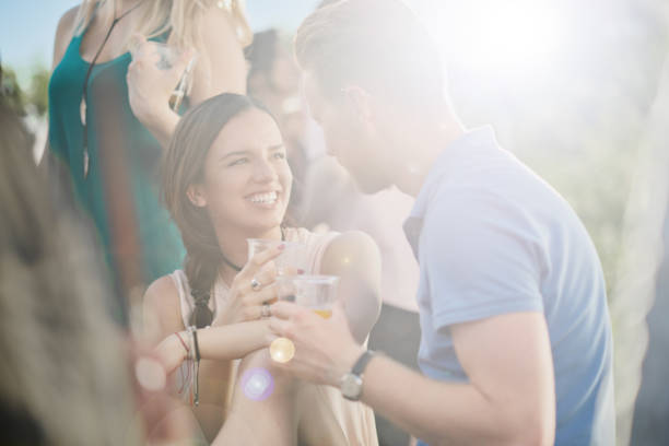 istock Couple flitring at outdoor party 881507736