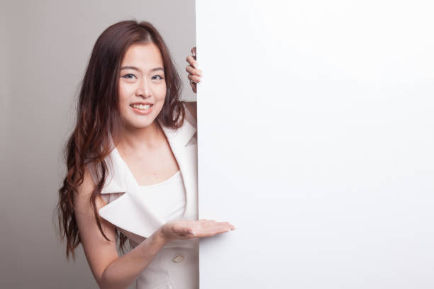 istock Young Asian woman present blank sign with palm hand. 881510846