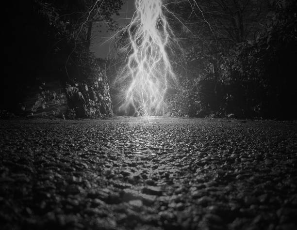 istock Surreal scene in a dark path where a powerful lightning strikes 881514952
