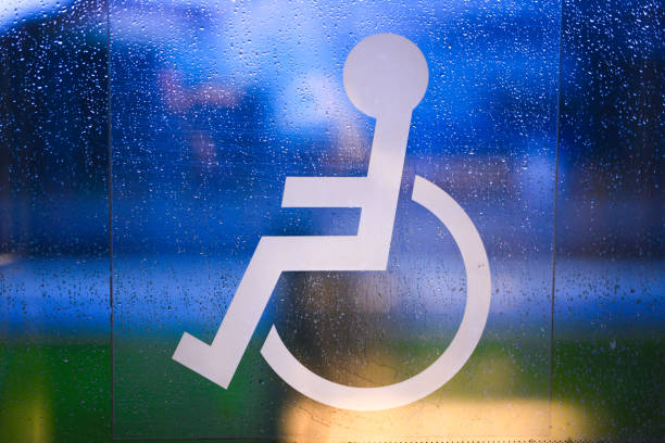White Disabled Sign on tram door. Traffic lights in background. No people