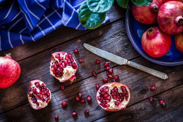 istock Fresh organic pomegranates on rustic wooden table 881516048