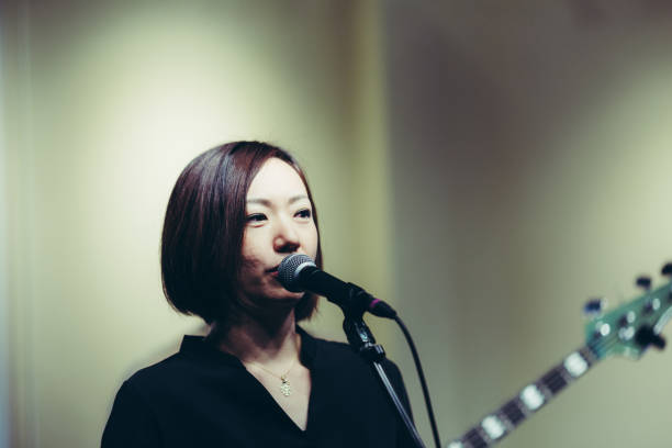 istock Female singer singing on stage 881519244