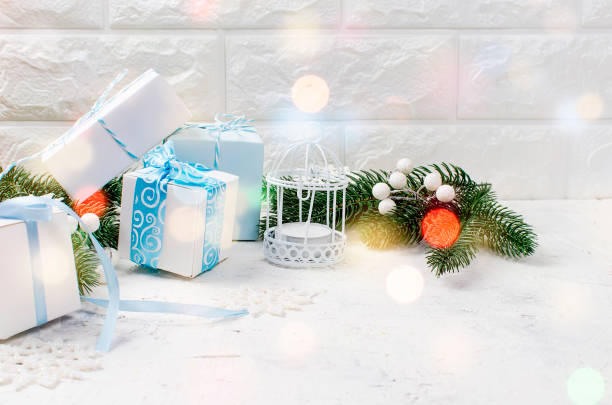 istock Christmas fir branches and gifts boxes on white background. 881519744