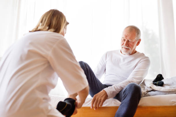 istock Health visitor and senior man during home visit. 881520062