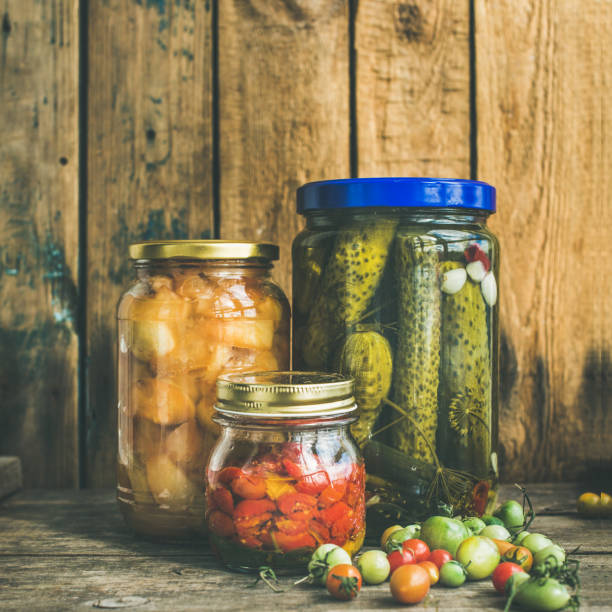 istock Autumn pickled vegetables in jars, copy space, square crop 881522330