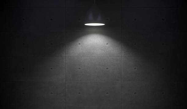 istock Lamp Hanging In Front Of Concrete Wall 881524626