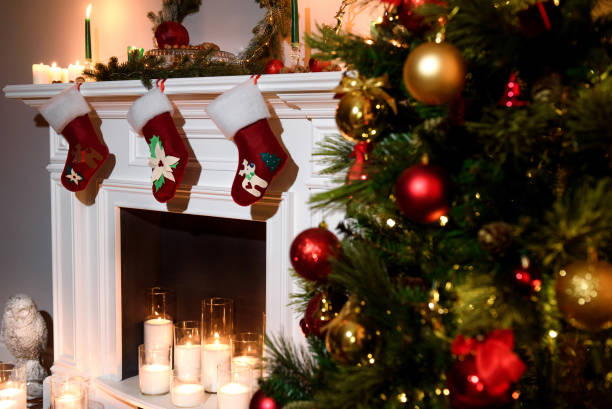 istock decorated tree and a warm fireplace with present toys 881526440