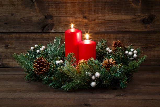 istock Second Advent - Decorated Advent wreath with two red burning candles on a wooden background 881529330