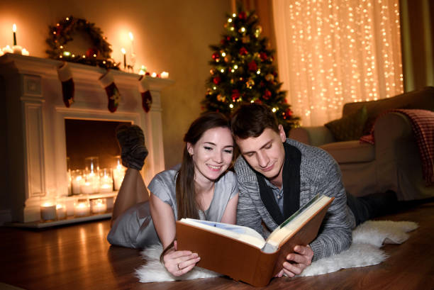 istock Couple hugging in front of fireplace 881537908