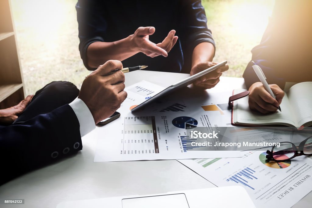 Business people using pen,tablet,notebook are planning a marketing plan to improve the quality of their sales in the future. Business Stock Photo