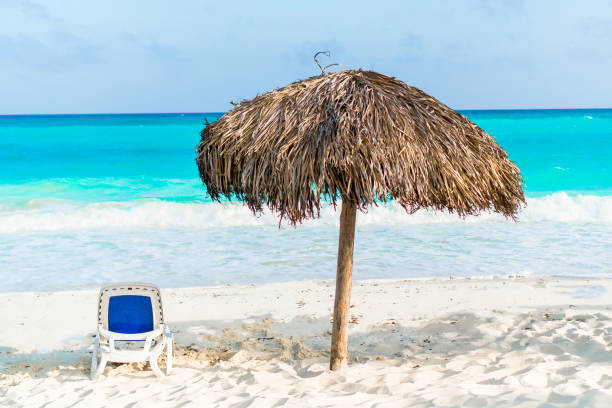 istock Beach sunbed and umbrella on white beach 881543346