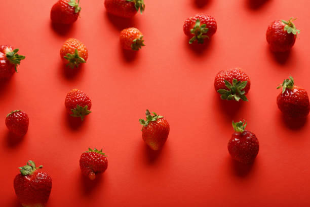 istock fresh and organic strawberries on red 881549274
