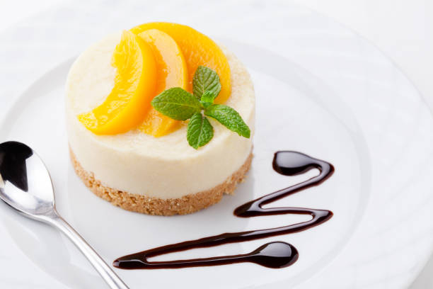 istock Small Homemade Cheesecake With Poached Peaches 881549322