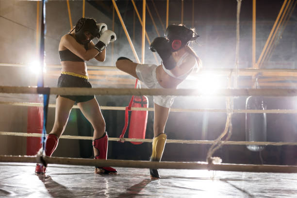 istock Determined athletic women fighting on a kickboxing match. 881550214