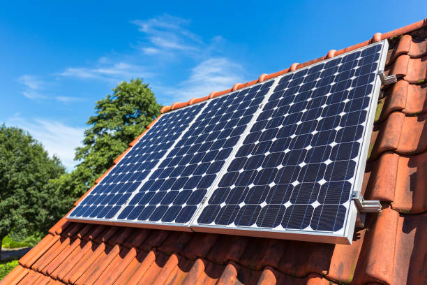 Row of solar collectors  on orange roof stock photo