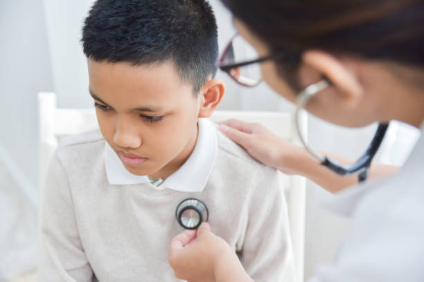 istock Female Doctor examining a little boy. 881566636