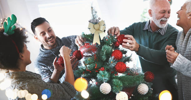 istock Family decorating a Christmas tree. 881571458