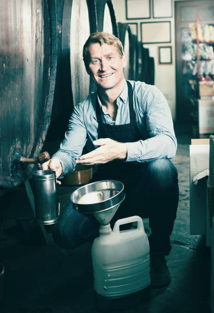 istock Male seller in wine cellar 881571686