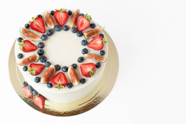 istock Cake with whipped white cream, decorated with fresh strawberries, blueberries and figs. 881574928
