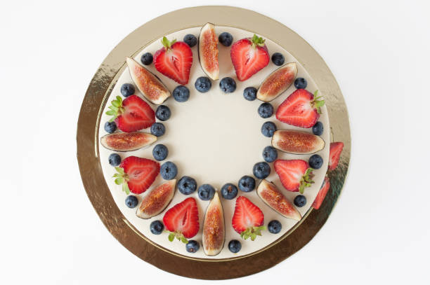 istock Cake with whipped white cream, decorated with fresh strawberries, blueberries and figs. 881574930