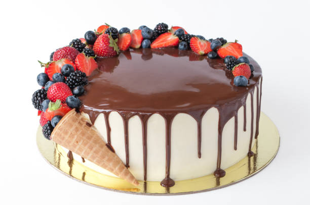 istock Cake in chocolate, decorated with waffle cone, strawberries, blueberries and blackberries. 881575886