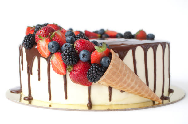 istock Cake in chocolate, decorated with waffle cone, strawberries, blueberries and blackberries. 881575944