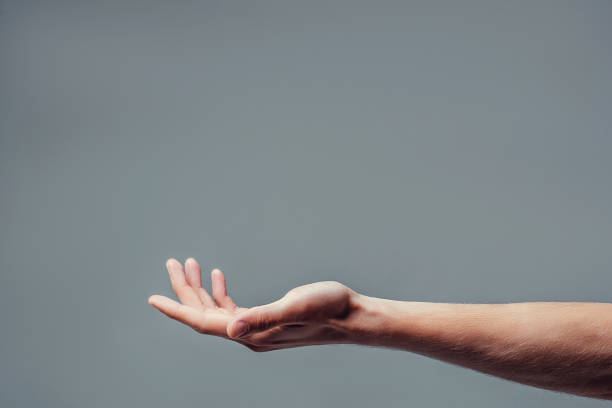 handsome man on grey background. - hand open imagens e fotografias de stock