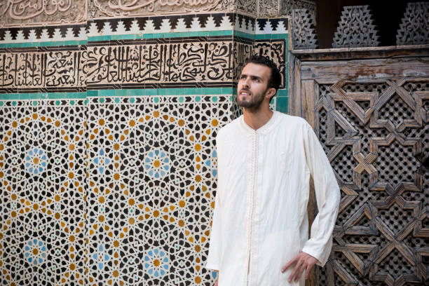 istock Arab man wearing traditional long white shirt 881579814