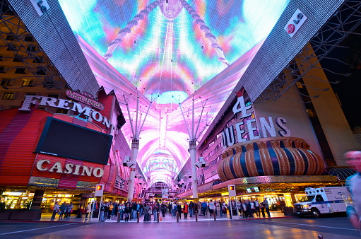 Tourists enjoying the nightlife on the famous Fremont Street in Las Vegas, Navada. Fremont Street features casinos, live music, performers and a 3 block long LED canopy where there's light and sound shows every night.