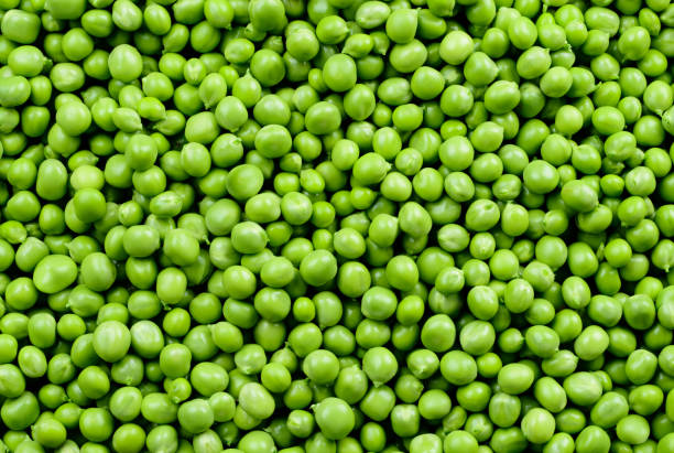 istock Green Peas. Green background. Peas background. Top view. 881582988